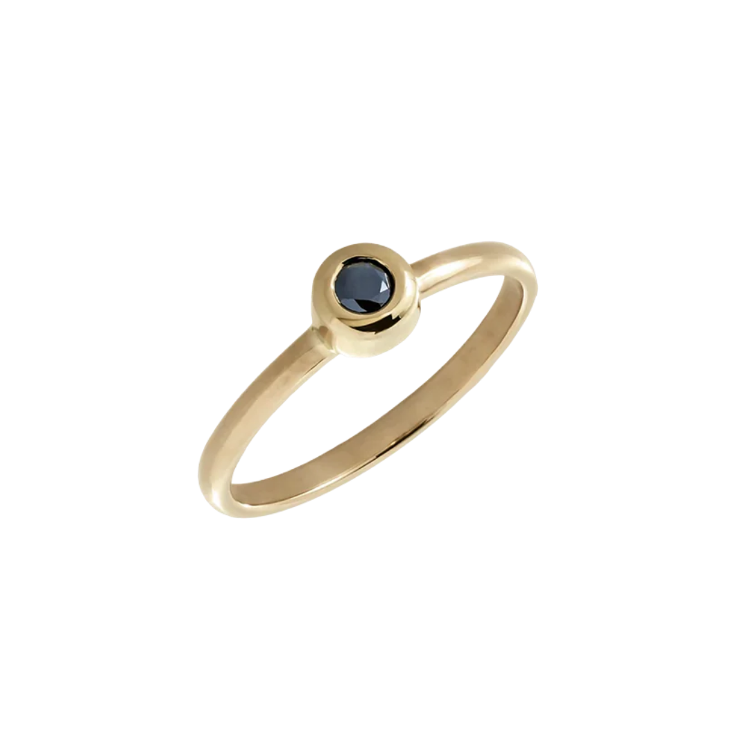 Minimalist gold ring with a black diamond in a bezel setting