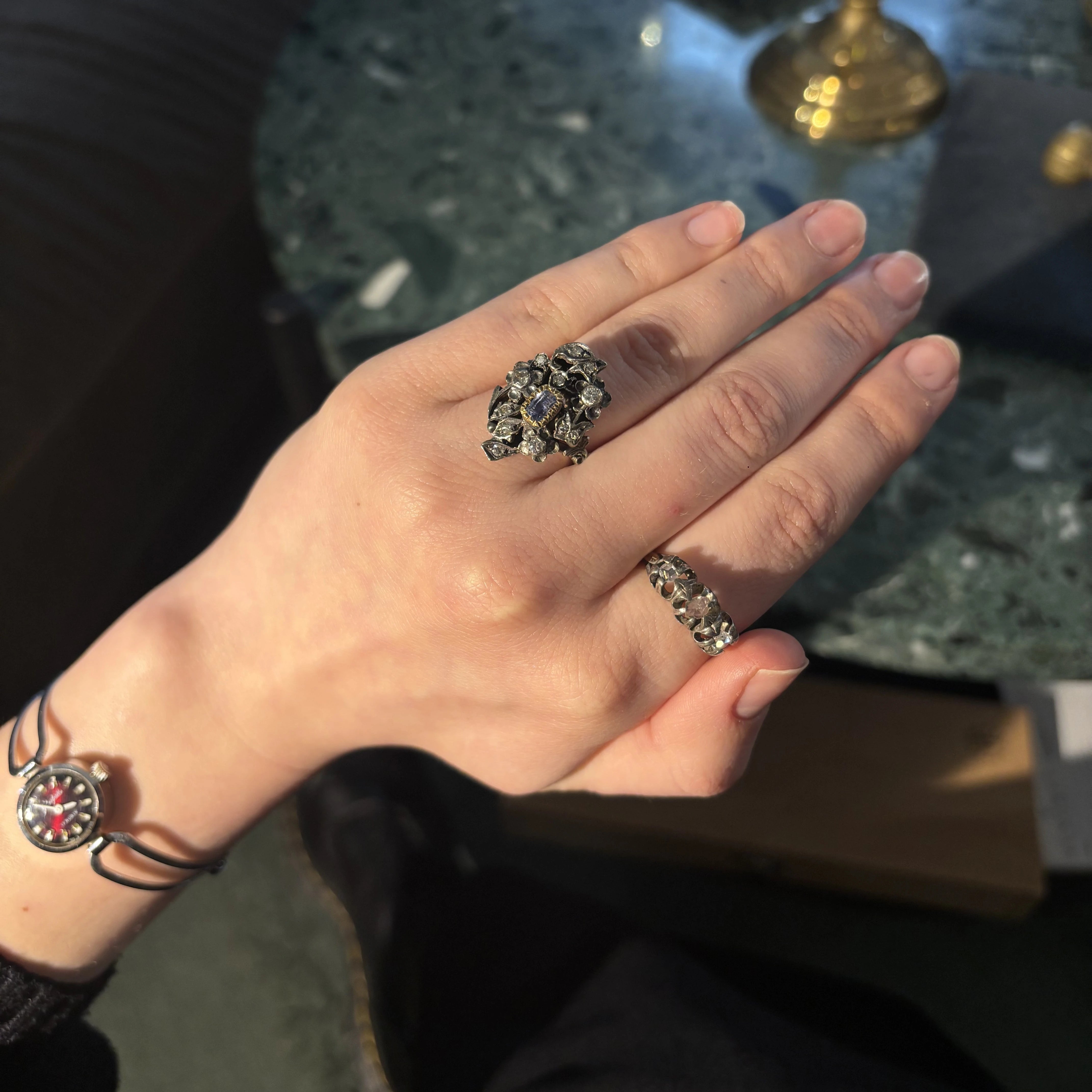 Gold ring with diamonds and a sapphire in the Art Nouveau style